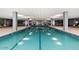 Beautiful indoor lap pool featuring three lanes, symmetrical design, and neutral tile flooring at 7167 E Rancho Vista Dr # 4010, Scottsdale, AZ 85251