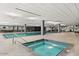 Relaxing indoor pool and hot tub area with deck chairs and modern fixtures at 7167 E Rancho Vista Dr # 4010, Scottsdale, AZ 85251
