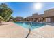 Relaxing community pool area with lounge chairs, umbrellas, and lush landscaping for residents to enjoy at 7464 N 43Rd Ave, Glendale, AZ 85301