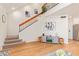 Spacious living room with staircase, wood floors, and stylish furnishings at 7464 N 43Rd Ave, Glendale, AZ 85301