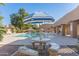 Inviting community pool area with a table, lounge chairs, and clear blue water, perfect for relaxation at 7464 N 43Rd Ave, Glendale, AZ 85301