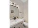 Powder room featuring modern black fixtures, large vanity mirror, and tile flooring at 824 W Mesquite St, Gilbert, AZ 85233