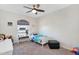 Sunny bedroom with ceiling fan, carpet and window overlooking front yard at 824 W Mesquite St, Gilbert, AZ 85233