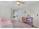 Charming bedroom featuring carpet, ceiling fan and window at 824 W Mesquite St, Gilbert, AZ 85233