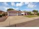 Attractive single-Gathering home showcasing a two-car garage, large driveway, and well-maintained landscaping at 824 W Mesquite St, Gilbert, AZ 85233