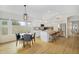 Kitchen features sleek white cabinets, stainless appliances, an island, and eat-in table at 824 W Mesquite St, Gilbert, AZ 85233