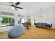 Bright, open living room with hardwood floors, grand piano, and modern dining set at 824 W Mesquite St, Gilbert, AZ 85233