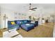 Comfortable living room with blue sectional sofa, ottoman, ceiling fan, and decor at 824 W Mesquite St, Gilbert, AZ 85233