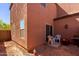 Private backyard with a patio, chairs, and sliding glass doors for relaxation and entertaining at 8244 W Albeniz Pl, Phoenix, AZ 85043