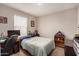 Comfortable bedroom features a well-lit desk, closet and cozy decor accents at 8244 W Albeniz Pl, Phoenix, AZ 85043