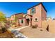Quaint two-story home featuring a low-maintenance yard and covered porch at 8244 W Albeniz Pl, Phoenix, AZ 85043