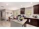 Bright kitchen area featuring granite countertops, an island, and an adjacent dining area at 8244 W Albeniz Pl, Phoenix, AZ 85043