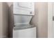 Efficient laundry area with stacked washer and dryer, saving space with a sleek design at 8244 W Albeniz Pl, Phoenix, AZ 85043
