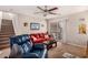 View of the living room showing a ceiling fan, carpet, and a sliding glass door at 8244 W Albeniz Pl, Phoenix, AZ 85043