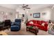 Comfortable living room with carpet, a ceiling fan, and staircase to the upper level at 8244 W Albeniz Pl, Phoenix, AZ 85043