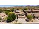Beautiful community view featuring a two-story home with three-car garage, desert landscaping, and mountain views at 9052 E Hobart St, Mesa, AZ 85207