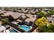 Beautiful aerial view of a home showcasing a backyard pool, covered patio, and desert landscaping in a residential neighborhood at 9052 E Hobart St, Mesa, AZ 85207