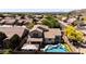 Picture of a house with beautiful backyard pool, patio, artificial grass, and view of neighborhood in a sunny desert community at 9052 E Hobart St, Mesa, AZ 85207