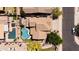 Top-down aerial image of a home highlighting a backyard pool, patio area, lush greenery, and desert landscaping in a community at 9052 E Hobart St, Mesa, AZ 85207