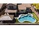 Private backyard oasis with a sparkling pool, covered patio, lounge chairs, and artificial turf for easy maintenance at 9052 E Hobart St, Mesa, AZ 85207
