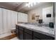 Bathroom featuring a double vanity, neutral paint, framed mirror, and updated lighting fixtures at 9052 E Hobart St, Mesa, AZ 85207