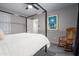 Bright bedroom features gray carpet, neutral walls, and a rocking chair with a four-poster bed at 9052 E Hobart St, Mesa, AZ 85207