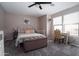 Cozy bedroom featuring neutral walls, gray carpet, and a metal bed frame with a chest at the foot at 9052 E Hobart St, Mesa, AZ 85207