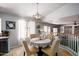 Casual dining area with table and chairs, bright natural light, and views to an upstairs living area at 9052 E Hobart St, Mesa, AZ 85207