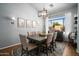 Elegant dining room with stylish light fixture and large windows offering natural light at 9052 E Hobart St, Mesa, AZ 85207