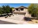Charming two-story home with a three-car garage, a well-maintained lawn, and mature trees for added curb appeal at 9052 E Hobart St, Mesa, AZ 85207