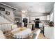 Open kitchen view featuring a dining area, and staircase to a loft. White cabinets and granite counters at 9052 E Hobart St, Mesa, AZ 85207