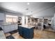 Open concept kitchen with large center island, adjacent dining area, and access to the living space beyond at 9052 E Hobart St, Mesa, AZ 85207