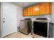 Laundry room equipped with modern washer and dryer units and ample storage space at 9052 E Hobart St, Mesa, AZ 85207