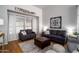 Comfortable living room with neutral color scheme, accent pillows and wood flooring at 9052 E Hobart St, Mesa, AZ 85207