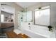 Serene main bathroom with a soaking tub, glass shower, and a view into the main bedroom at 9052 E Hobart St, Mesa, AZ 85207