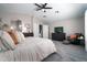 Inviting main bedroom with a king bed, a ceiling fan, and a glimpse into the main bathroom at 9052 E Hobart St, Mesa, AZ 85207