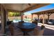 Inviting outdoor patio with comfortable seating, a dining table, and a view of the backyard pool at 9052 E Hobart St, Mesa, AZ 85207