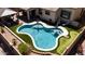 Stunning backyard pool with artificial turf, patio seating, and lush landscaping perfect for relaxation and entertainment at 9052 E Hobart St, Mesa, AZ 85207