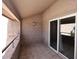 Private balcony with tiled floor and sliding glass door to living space at 10828 N Biltmore Dr # 230, Phoenix, AZ 85029