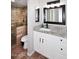 Modern bathroom with white cabinets, granite counters, and glass shower with bronze fixtures at 10828 N Biltmore Dr # 230, Phoenix, AZ 85029