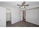 Bedroom with gray carpet, ceiling fan and walk in closet at 10828 N Biltmore Dr # 230, Phoenix, AZ 85029