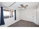 Bedroom with gray carpet and a ceiling fan and light fixture at 10828 N Biltmore Dr # 230, Phoenix, AZ 85029