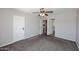 A view of a carpeted bedroom including two entryways and a ceiling fan at 10828 N Biltmore Dr # 230, Phoenix, AZ 85029