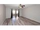 Spacious bedroom featuring wood floors, a ceiling fan, and sliding glass doors to the balcony at 10828 N Biltmore Dr # 230, Phoenix, AZ 85029