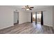 Light-filled bedroom boasts modern wood floors, ceiling fan, and glass doors to balcony at 10828 N Biltmore Dr # 230, Phoenix, AZ 85029