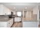 Open kitchen with granite countertops, modern stainless steel appliances, white cabinets, and a stainless steel dishwasher at 10828 N Biltmore Dr # 230, Phoenix, AZ 85029