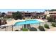 Community pool with lounge chairs and covered seating surrounded by manicured landscaping at 10828 N Biltmore Dr # 230, Phoenix, AZ 85029