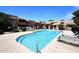 Community pool area featuring lounge chairs for residents and shade covered picnic areas at 10828 N Biltmore Dr # 230, Phoenix, AZ 85029