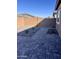 Low-maintenance backyard with gravel landscaping, pavers, block wall, and desert plants at 11074 W Tonto St, Avondale, AZ 85323