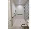 Bright bathroom with textured hexagon tile, grab bars and accessible toilet for enhanced safety at 11074 W Tonto St, Avondale, AZ 85323